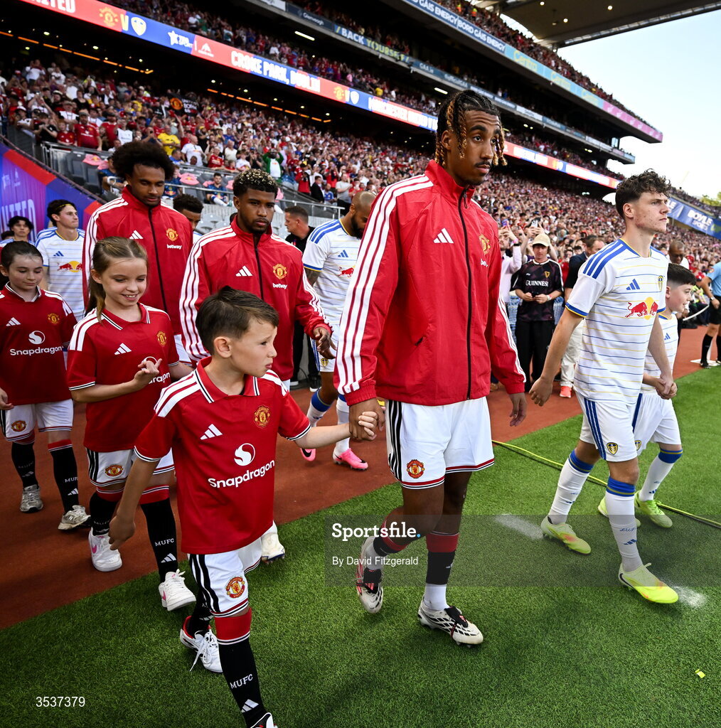 12 August 2026; Leny Yoro of Manchester United walks out with a mascot before the pre-season friendly match between Manchester United and Leeds United at Croke Park in Dublin. Photo by David Fitzgerald/Sportsfile