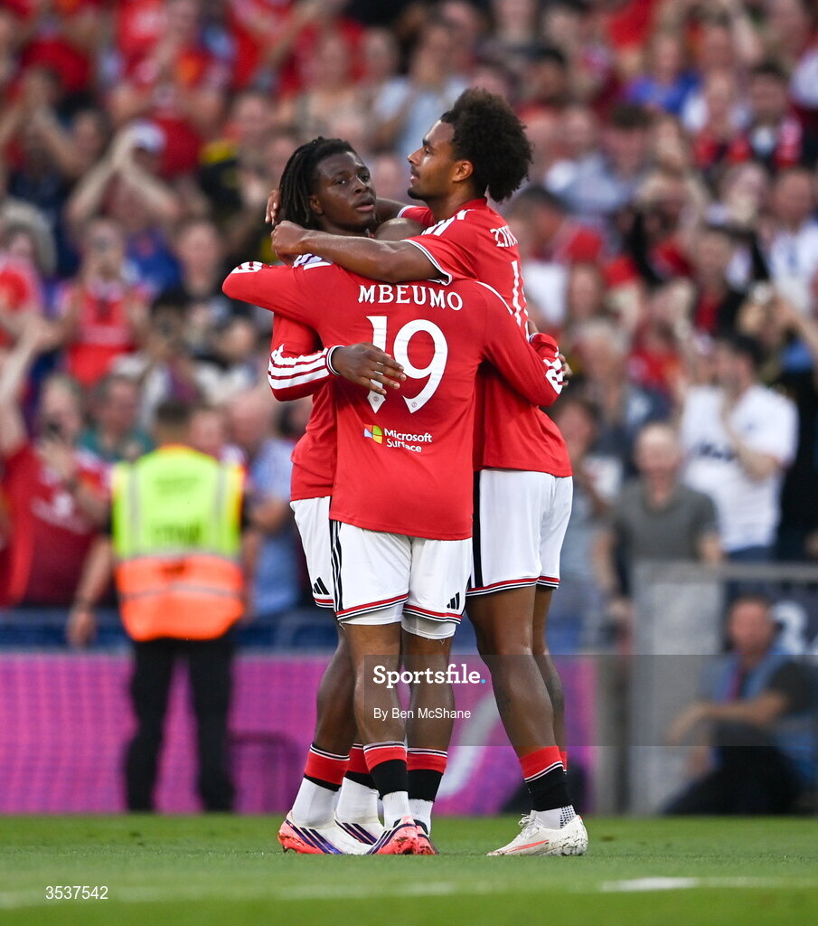 12 August 2026; Joshua Zirkzee, right, celebrates with Manchester United teammates Patrick Dorgu, left, and Bryan Mbeumo after scoring their side's first goal during the pre-season friendly match between Manchester United and Leeds United at Croke Park in Dublin. Photo by Ben McShane/Sportsfile