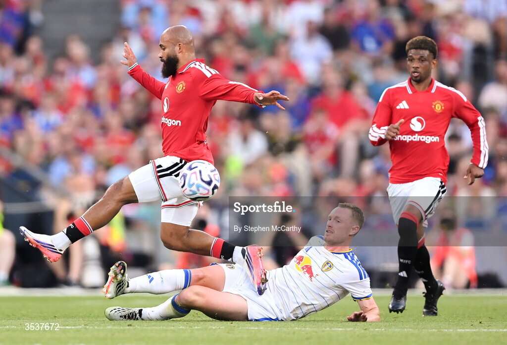12 August 2026; Bryan Mbeumo of Manchester United is tackled by Sean Longstaff of Leeds United during the pre-season friendly match between Manchester United and Leeds United at Croke Park in Dublin. Photo by Stephen McCarthy/Sportsfile