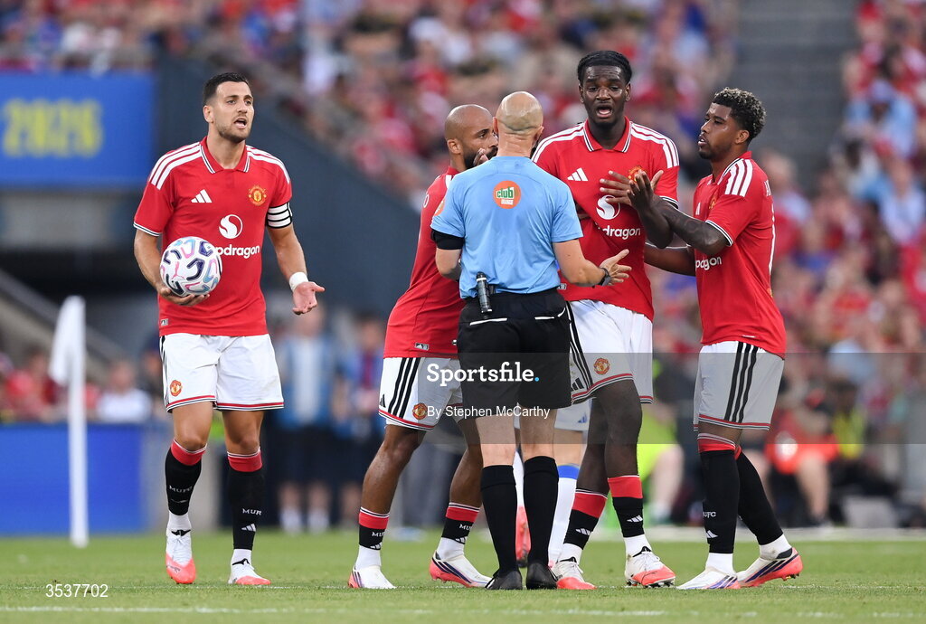 12 August 2026; Manchester United players, from left, Diogo Dalot, Bryan Mbeumo, Ayden Heaven and Andrey Santos appeal to referee Neil Doyle during the pre-season friendly match between Manchester United and Leeds United at Croke Park in Dublin. Photo by Stephen McCarthy/Sportsfile