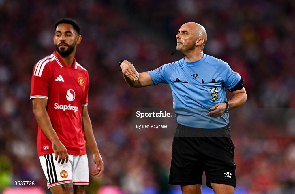 12 August 2026; Referee Neil Doyle and Matheus Cunha of Manchester United during the pre-season friendly match between Manchester United and Leeds United at Croke Park in Dublin. Photo by Ben McShane/Sportsfile