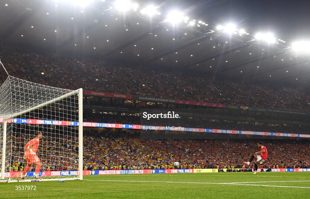 12 August 2026; Matheus Cunha of Manchester United scores his penalty past Leeds United goalkeeper Alex Cairns during a penalty shootout at the end of the pre-season friendly match between Manchester United and Leeds United at Croke Park in Dublin. Photo by Stephen McCarthy/Sportsfile