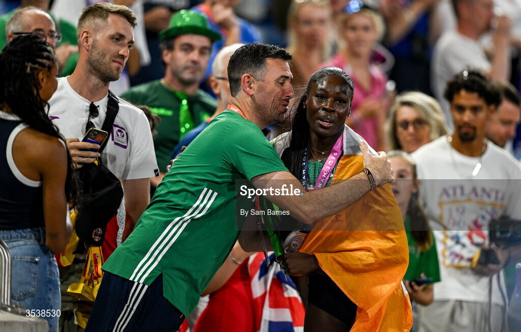 13 August 2026; Rhasidat Adeleke of Ireland celebrates with Team Ireland physio Declan Monaghan after finishing second and winning the silver medal in the women's 200m final during day four of the European Athletics Championships 2026 at Alexander Stadium in Birmingham, England. Photo by Sam Barnes/Sportsfile