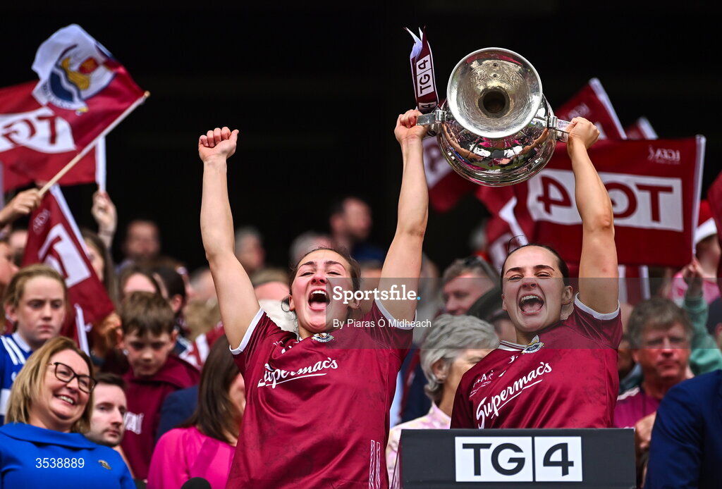 2 August 2026; Galway players Chellene Trill, left, and Andrea Trill lift the Brendan Martin Cup after the LGFA TG4 All-Ireland Senior Championship final match between Galway and Kerry at Croke Park in Dublin. Photo by Piaras Ó Mídheach/Sportsfile