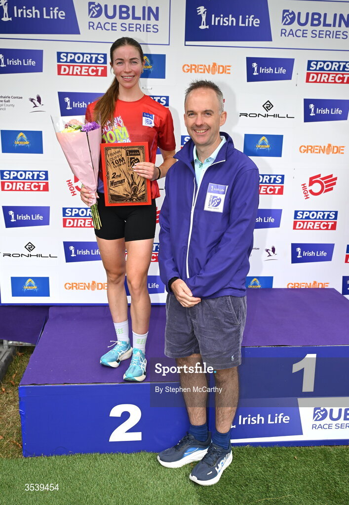 15 August 2026; Sarah Diamond of Kilcoole AC is presented with her second placed prize by Oisin O’Shaughnessy managing director employer solutions, Irish Life, during the 2026 Irish Life Frank Duffy 10 Mile, in the Phoenix Park, Dublin. Thousands of runners took part in the sold out Irish Life Frank Duffy 10 Mile, the second event in the 2026 Irish Life Dublin Race Series. Photo by Stephen McCarthy/Sportsfile