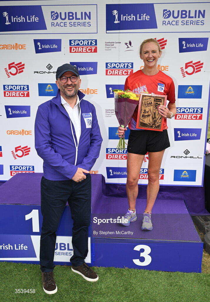 15 August 2026; Pamela Kirk of RaodRunners AC is presented with her third place prize by Brendan McEvoy, chief customer marketing society and innovation officer, Irish Life, during the 2026 Irish Life Frank Duffy 10 Mile, in the Phoenix Park, Dublin. Thousands of runners took part in the sold out Irish Life Frank Duffy 10 Mile, the second event in the 2026 Irish Life Dublin Race Series. Photo by Stephen McCarthy/Sportsfile