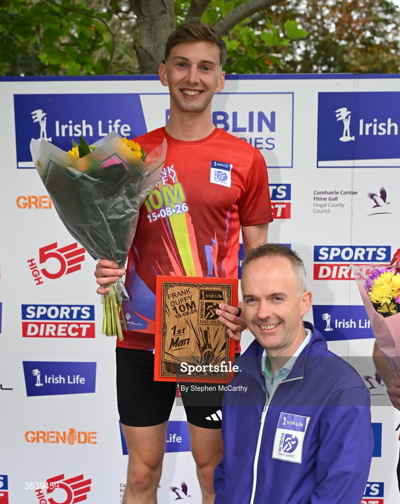 15 August 2026; Cormac Dalton of Mullingar Harriers AC is presented with his first placed prize by Oisin O’Shaughnessy managing director employer solutions, Irish Life, during the 2026 Irish Life Frank Duffy 10 Mile, in the Phoenix Park, Dublin. Thousands of runners took part in the sold out Irish Life Frank Duffy 10 Mile, the second event in the 2026 Irish Life Dublin Race Series. Photo by Stephen McCarthy/Sportsfile