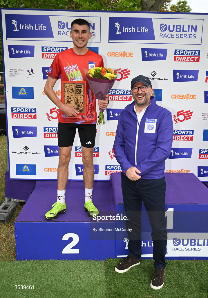 15 August 2026; Michael Brady of Raheny Shamrock AC is presented with his second placed prize by Brendan McEvoy, chief customer marketing society and innovation officer, Irish Life, during the 2026 Irish Life Frank Duffy 10 Mile, in the Phoenix Park, Dublin. Thousands of runners took part in the sold out Irish Life Frank Duffy 10 Mile, the second event in the 2026 Irish Life Dublin Race Series. Photo by Stephen McCarthy/Sportsfile