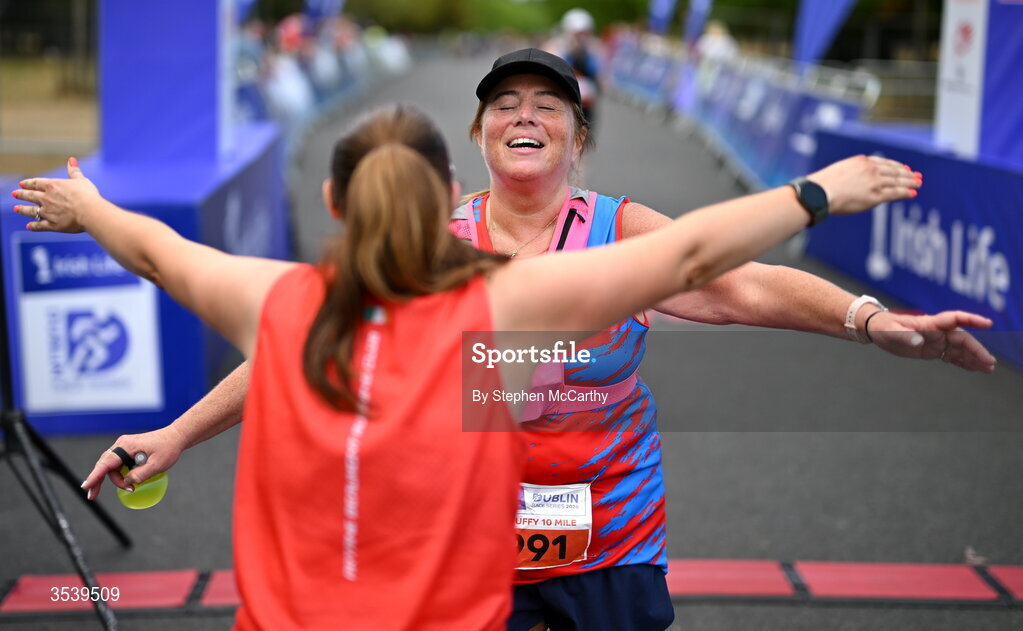 15 August 2026; Athletes from Artane/Beaumont Running Club AC embrace after finishing the 2026 Irish Life Frank Duffy 10 Mile, in the Phoenix Park, Dublin. Thousands of runners took part in the sold out Irish Life Frank Duffy 10 Mile, the second event in the 2026 Irish Life Dublin Race Series. Photo by Stephen McCarthy/Sportsfile