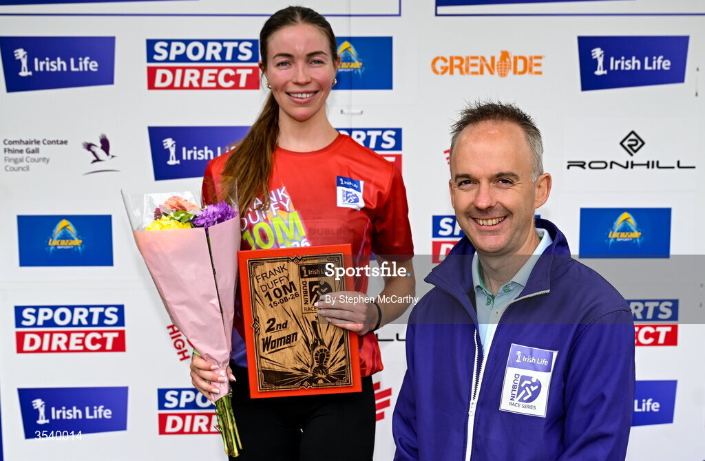15 August 2026; Sarah Diamond of Kilcoole AC is presented with her second placed prize by Oisin O’Shaughnessy managing director employer solutions, Irish Life, during the 2026 Irish Life Frank Duffy 10 Mile, in the Phoenix Park, Dublin. Thousands of runners took part in the sold out Irish Life Frank Duffy 10 Mile, the second event in the 2026 Irish Life Dublin Race Series. Photo by Stephen McCarthy/Sportsfile