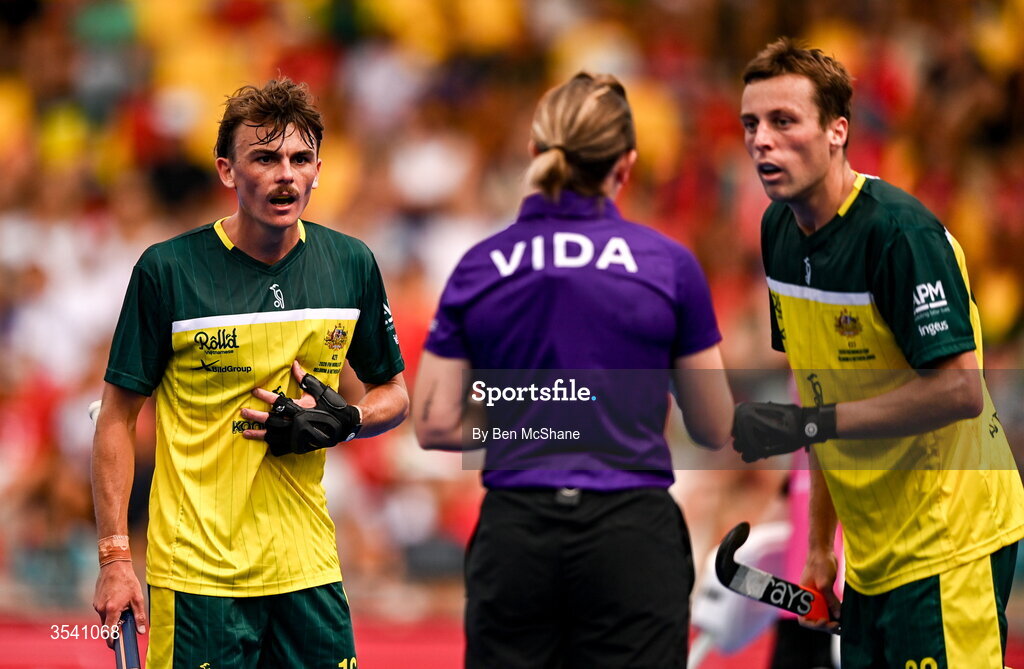 16 August 2026; Tim Howard, left, and Ky Willott of Australia remomstrate with umpire Rachael Williams during the FIH Men's Hockey World Cup 2026 Pool C match between Ireland and Australia at the Belfius Hockey Arena in Wavre, Belgium. Photo by Ben McShane/Sportsfile