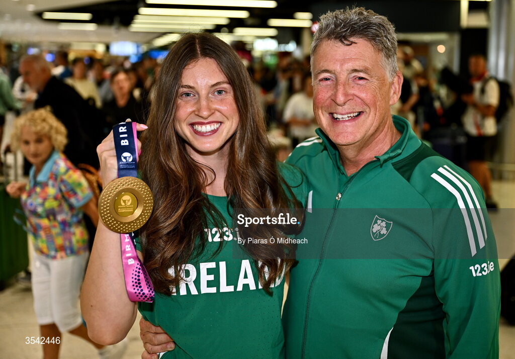 17 August 2026; Women’s heptathlon gold medalist Kate O'Connor with her father and coach Michael O'Connor at Dublin Airport on return from the 2026 European Athletics Championships in Birmingham, England. Photo by Piaras Ó Mídheach/Sportsfile