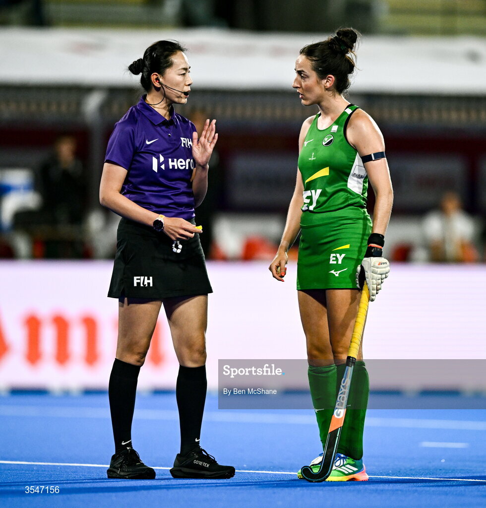 20 August 2026; Hannah McLoughlin of Ireland in conversation with umpire Liu Xiaoying during the FIH Women's Hockey World Cup 2026 Pool C match between Belgium and Ireland at the Belfius Hockey Arena in Wavre, Belgium. Photo by Ben McShane/Sportsfile