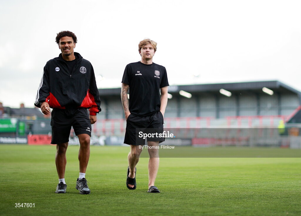 21 August 2026; Zane Myers of Bohemians, left, and Harry Vaughan walk the pitch before the SSE Airtricity Men’s Premier Division match between Bohemians and Derry City at Dalymount Park in Dublin. Photo by Thomas Flinkow/Sportsfile