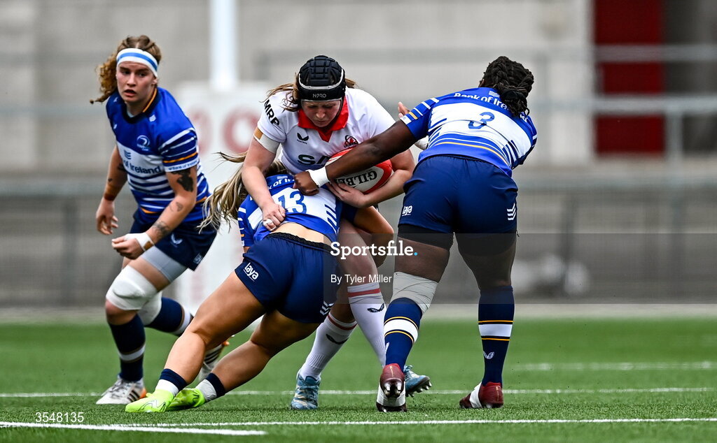 22 August 2026; Maebh Clenaghan of Ulster is tackled by Aoife Dalton, left, and Linda Djougang of Leinster during the Vodafone Womens Interprovincial Championship Round 3 match between Ulster and Leinster at Affidea Stadium in Belfast. Photo by Tyler Miller/Sportsfile