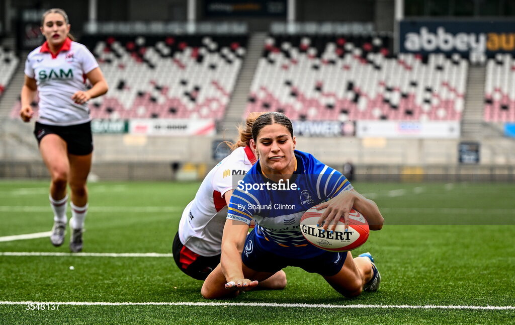 22 August 2026; Vicky Elmes Kinlan of Leinster scores her side's second try despite the efforts of Niamh Marley of Ulster during the Vodafone Womens Interprovincial Championship Round 3 match between Ulster and Leinster at Affidea Stadium in Belfast. Photo by Shauna Clinton/Sportsfile