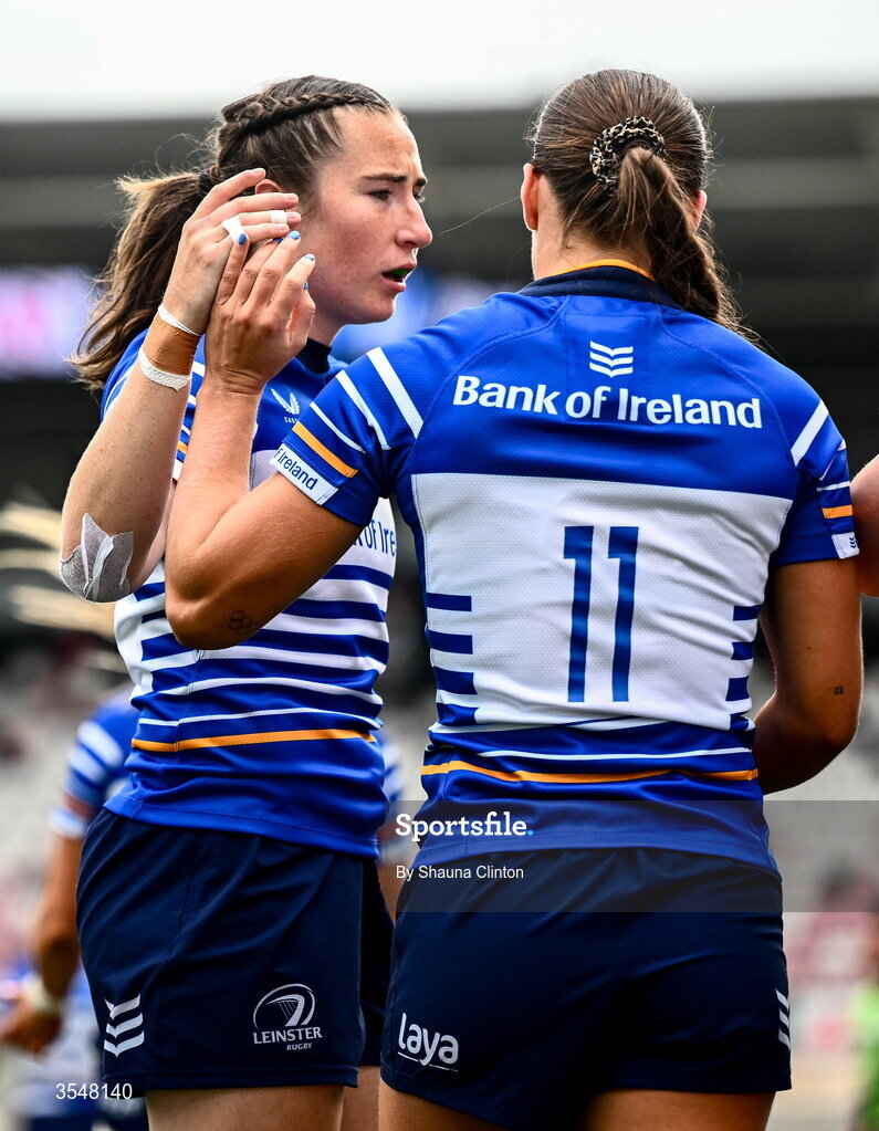 22 August 2026; Vicky Elmes Kinlan of Leinster, 11, is congratulated by team-mates after scoring her side's second try despite the efforts of Niamh Marley of Ulster during the Vodafone Womens Interprovincial Championship Round 3 match between Ulster and Leinster at Affidea Stadium in Belfast. Photo by Shauna Clinton/Sportsfile