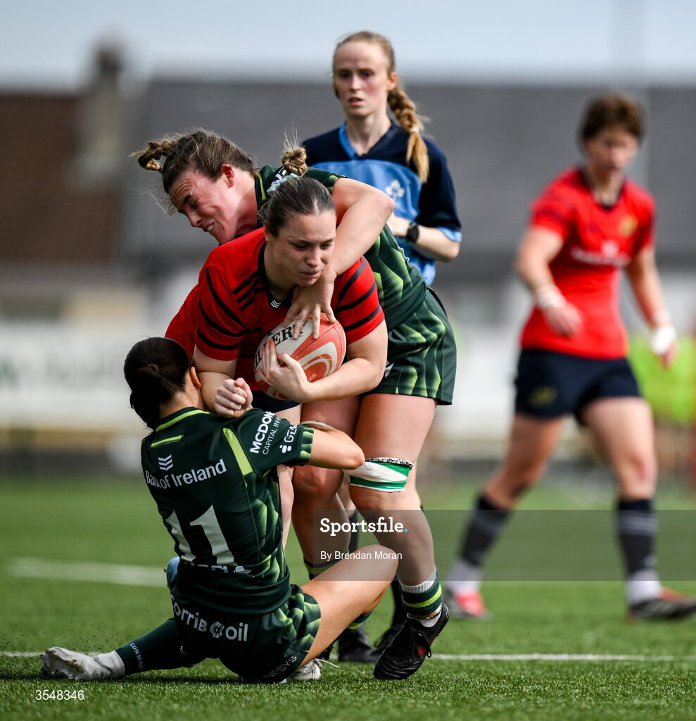 22 August 2026; Alana McInerney of Munster is tackled by Emily Foley and Emma Kelly of Connacht during the Vodafone Womens Interprovincial Championship Round 3 match between Connacht and Munster at Dexcom Stadium in Galway. Photo by Brendan Moran/Sportsfile