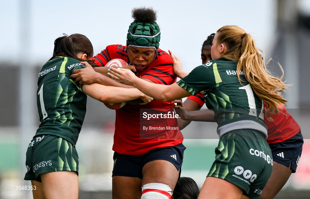 22 August 2026; Grace Moore of Munster is tackled by Connacht players Emily Foley and Lyndsay Clarke during the Vodafone Womens Interprovincial Championship Round 3 match between Connacht and Munster at Dexcom Stadium in Galway. Photo by Brendan Moran/Sportsfile