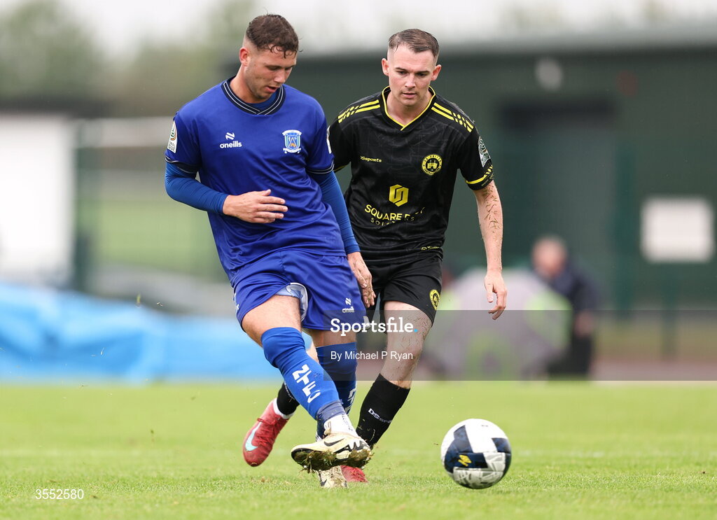 29 August 2026; Ethan Mills of Newbridge Town in action against Shane Barnes of CK United during the FAI National League Group 3 match between CK United and Newbridge Town at SETU Sports Complex in Carlow. Photo by Michael P Ryan/Sportsfile