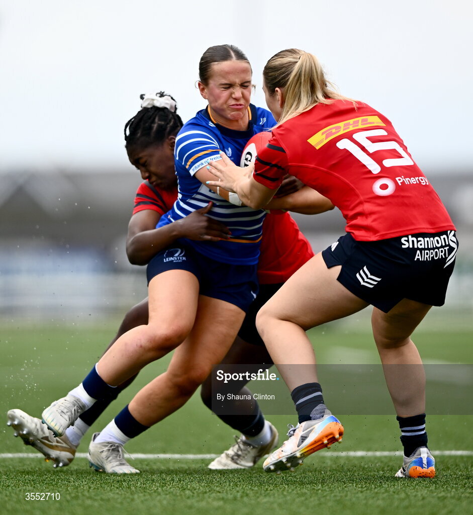29 August 2026; Robyn O'Connor of Leinster is tackled by Munster players Chisom Ugwueru, left, and Aoife Corey during the Vodafone Womens Interprovincial Championship final match between Munster and Leinster at Dexcom Stadium in Galway. Photo by Shauna Clinton/Sportsfile