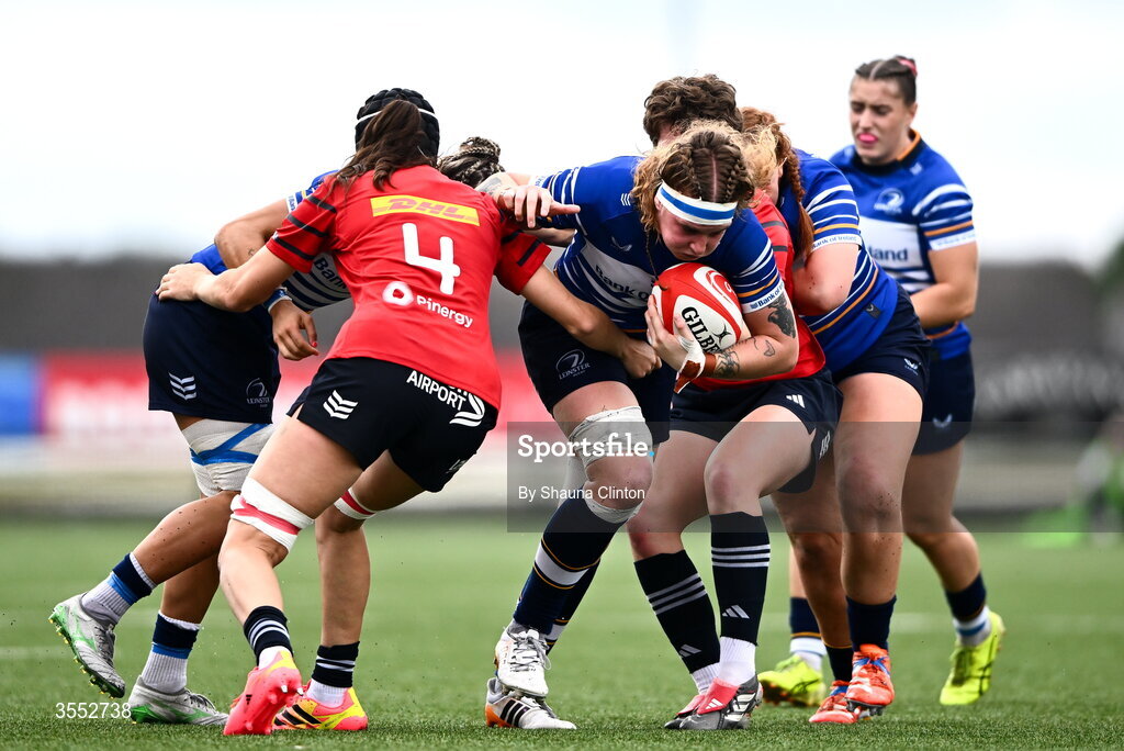 29 August 2026; Ruth Campbell of Leinster is tackled by Munster players Aoibhe O’Flynn, left, and Caitríona Finn during the Vodafone Womens Interprovincial Championship final match between Munster and Leinster at Dexcom Stadium in Galway. Photo by Shauna Clinton/Sportsfile