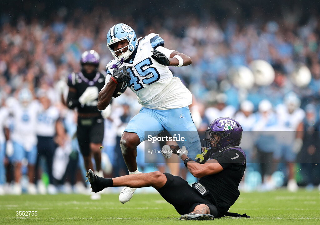 29 August 2026; North Carolina tight end Jelani Thurman #45 is tackled by TCU safety Julius Simms #7 during the 2026 Aer Lingus College Football Classic match between TCU and North Carolina at the Aviva Stadium in Dublin. Photo by Thomas Flinkow/Sportsfile