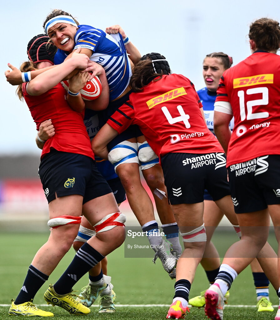 29 August 2026; Erin King of Leinster is tackled by Munster players Sally Kelly, left, and Aoibhe O’Flynn during the Vodafone Womens Interprovincial Championship final match between Munster and Leinster at Dexcom Stadium in Galway. Photo by Shauna Clinton/Sportsfile