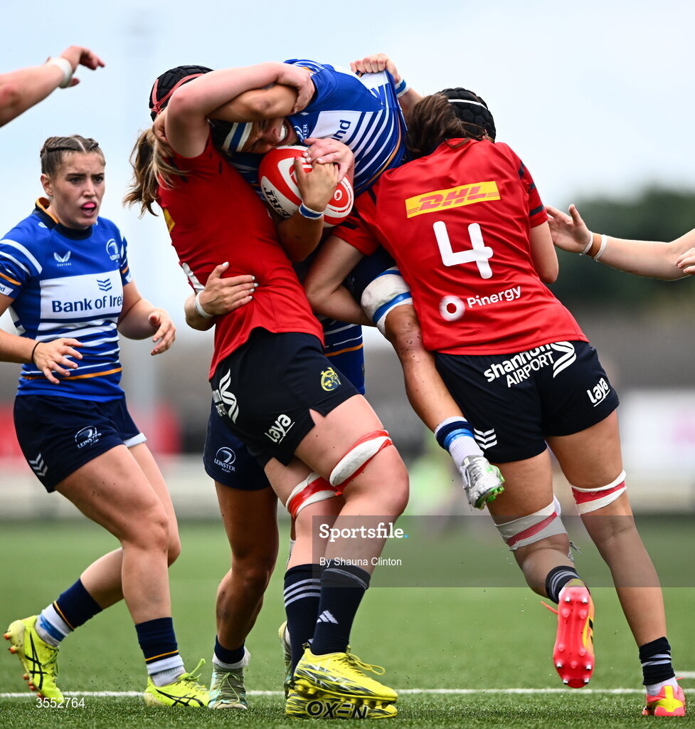 29 August 2026; Erin King of Leinster is tackled by Munster players Sally Kelly, left, and Aoibhe O’Flynn during the Vodafone Womens Interprovincial Championship final match between Munster and Leinster at Dexcom Stadium in Galway. Photo by Shauna Clinton/Sportsfile