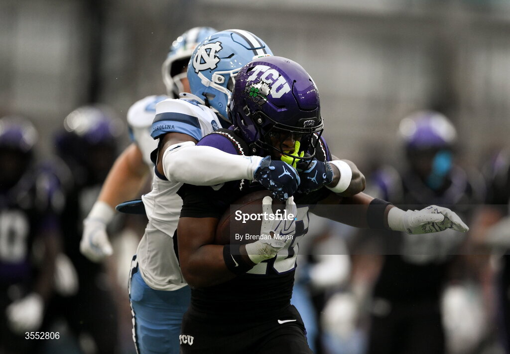 29 August 2026; TCU running back Jeremy Payne #26 is tackled by North Carolina defensive back Jaiden Patterson #18 during the 2026 Aer Lingus College Football Classic match between TCU and North Carolina at the Aviva Stadium in Dublin. Photo by Brendan Moran/Sportsfile