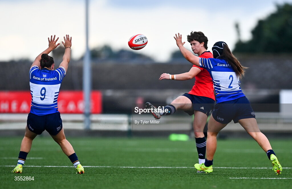 29 August 2026; Caitríona Finn of Munster kicks ahead of Sarah Delaney, right, and Katie Whelan of Leinster during the Vodafone Womens Interprovincial Championship final match between Munster and Leinster at Dexcom Stadium in Galway. Photo by Tyler Miller/Sportsfile