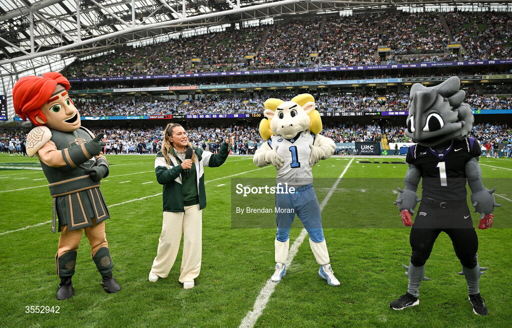 29 August 2026; American Football broadcaster Phoebe Schecter with the mascots during the 2026 Aer Lingus College Football Classic match between TCU and North Carolina at the Aviva Stadium in Dublin. Photo by Brendan Moran/Sportsfile