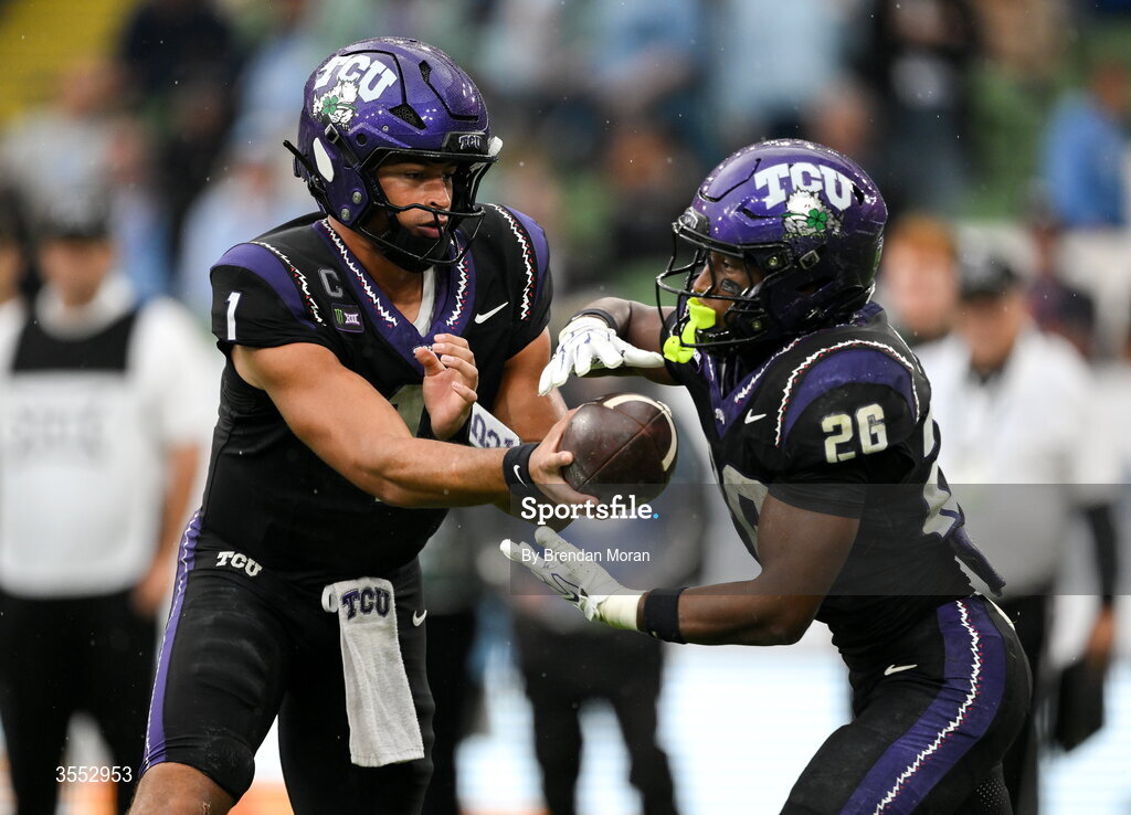 29 August 2026; TCU quarterback Jaden Craig #1 hands the ball ball to teammate TCU running back Jeremy Payne #26 during the 2026 Aer Lingus College Football Classic match between TCU and North Carolina at the Aviva Stadium in Dublin. Photo by Brendan Moran/Sportsfile