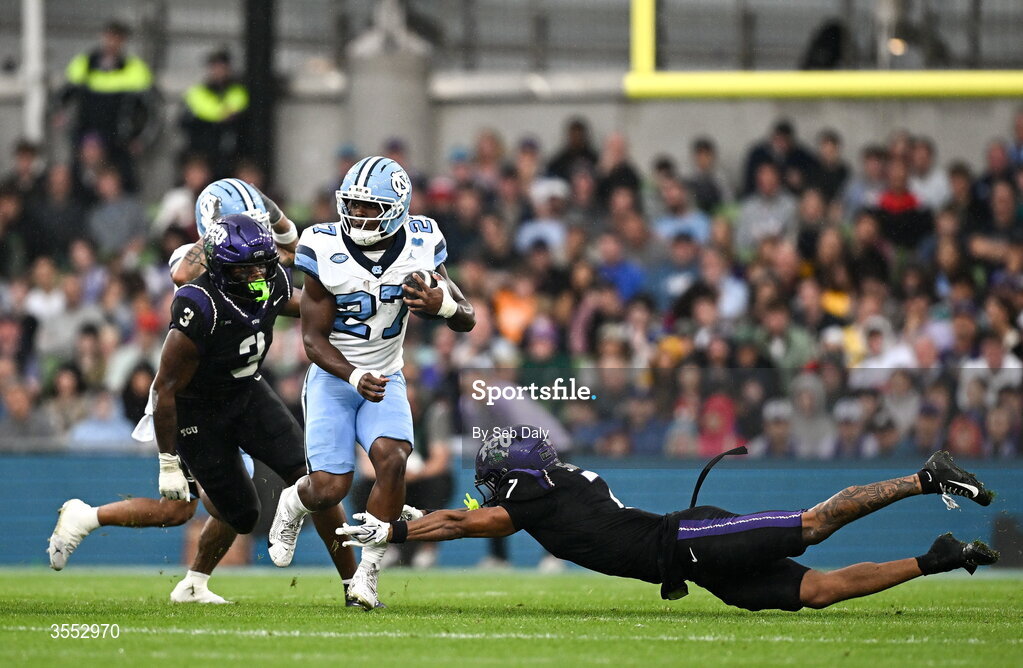 29 August 2026; North Carolina running back Jaylen McGill #27 evades the tackle of TCU safety Julius Simms #7 during the 2026 Aer Lingus College Football Classic match between TCU and North Carolina at the Aviva Stadium in Dublin. Photo by Seb Daly/Sportsfile