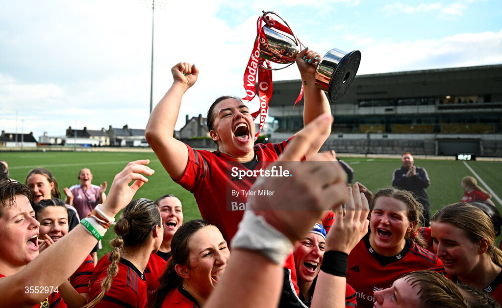 29 August 2026; Munster captain Maeve Óg O’Leary celebrates with the trophy and her team-mates after the Vodafone Womens Interprovincial Championship final match between Munster and Leinster at Dexcom Stadium in Galway. Photo by Tyler Miller/Sportsfile