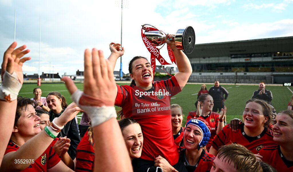 29 August 2026; Munster captain Maeve Óg O’Leary celebrates with the trophy and her team-mates after the Vodafone Womens Interprovincial Championship final match between Munster and Leinster at Dexcom Stadium in Galway. Photo by Tyler Miller/Sportsfile