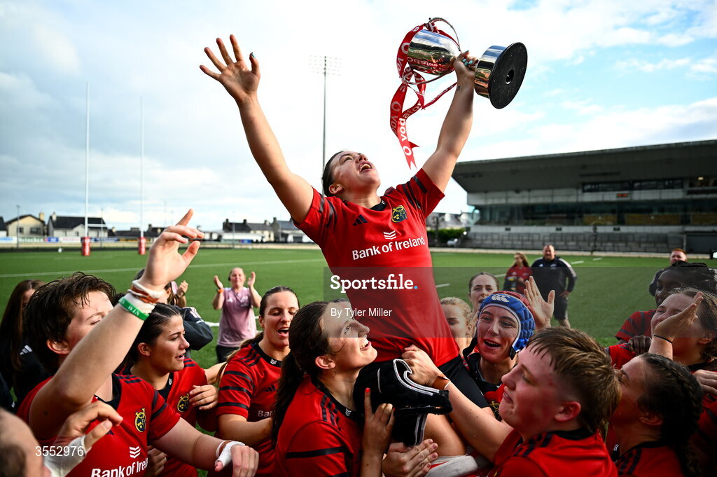29 August 2026; Munster captain Maeve Óg O’Leary celebrates with the trophy and her team-mates after the Vodafone Womens Interprovincial Championship final match between Munster and Leinster at Dexcom Stadium in Galway. Photo by Tyler Miller/Sportsfile