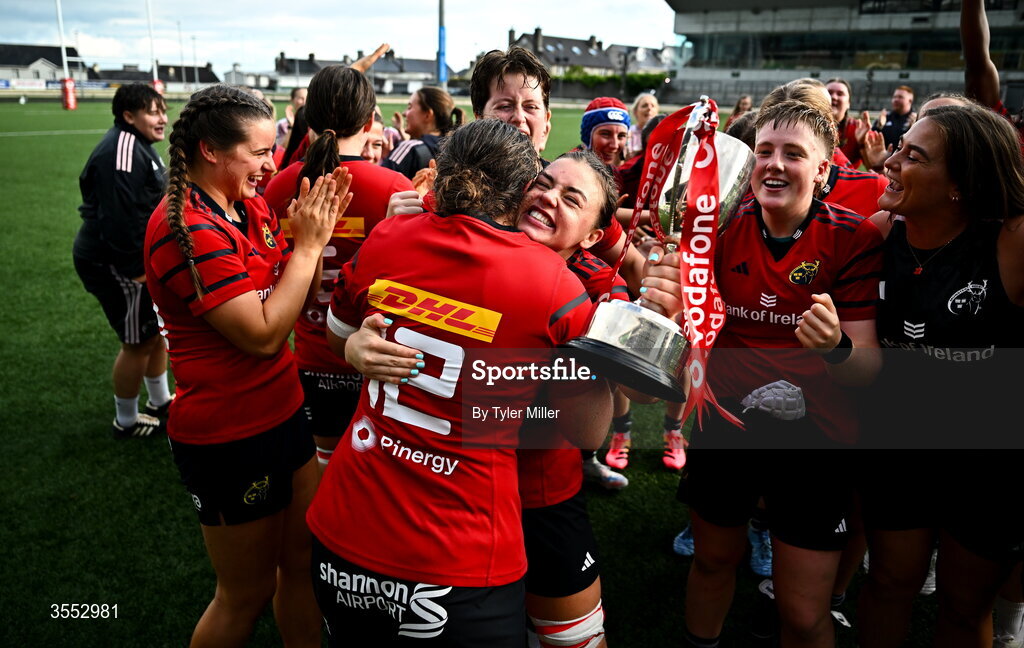 29 August 2026; Maeve Óg O’Leary, centre, and Enya Breen of Munster, 12, celebrate with the trophy after the Vodafone Womens Interprovincial Championship final match between Munster and Leinster at Dexcom Stadium in Galway. Photo by Tyler Miller/Sportsfile