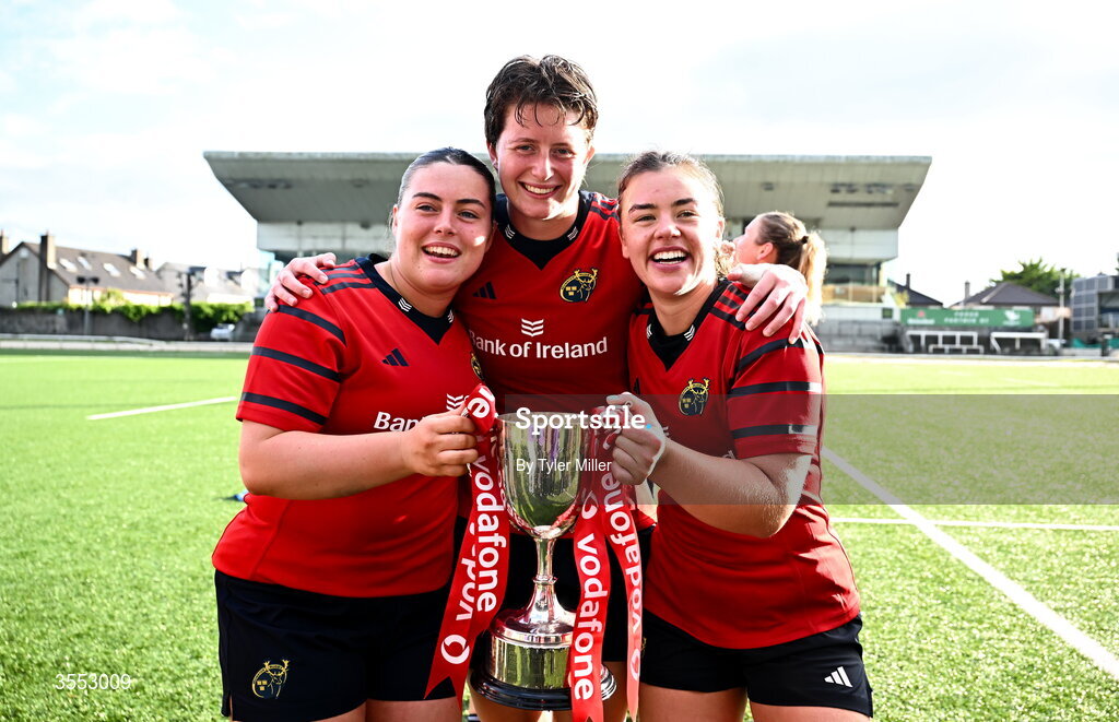 29 August 2026; Munster players, from left, Tuathla Ryan, Caitríona Finn and Maeve Óg O’Leary celebrate with the trophy after the Vodafone Womens Interprovincial Championship final match between Munster and Leinster at Dexcom Stadium in Galway. Photo by Tyler Miller/Sportsfile