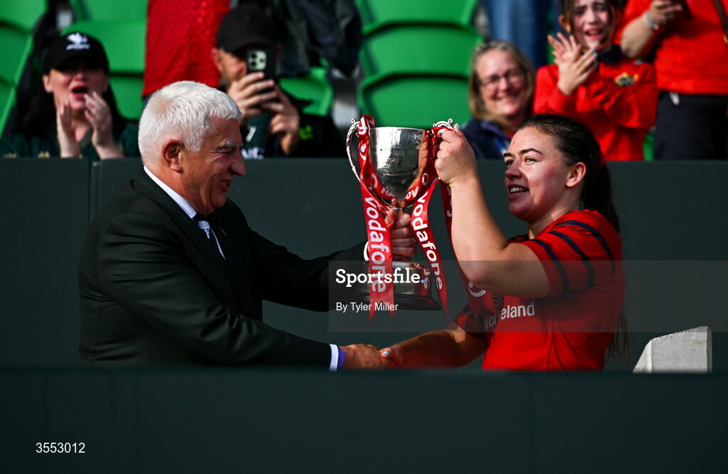 29 August 2026; IRFU President Tony O’Beirne presents the trophy to Maeve Óg O’Leary of Munster after the Vodafone Womens Interprovincial Championship final match between Munster and Leinster at Dexcom Stadium in Galway. Photo by Tyler Miller/Sportsfile