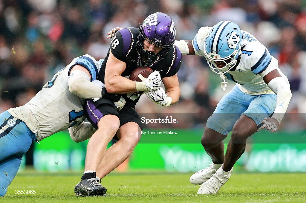29 August 2026; TCU wide receiver Ed Small #18 in action against North Carolina linebacker Derek McDonald #15 and North Carolina defensive back Greg Smith #1 during the 2026 Aer Lingus College Football Classic match between TCU and North Carolina at the Aviva Stadium in Dublin. Photo by Thomas Flinkow/Sportsfile