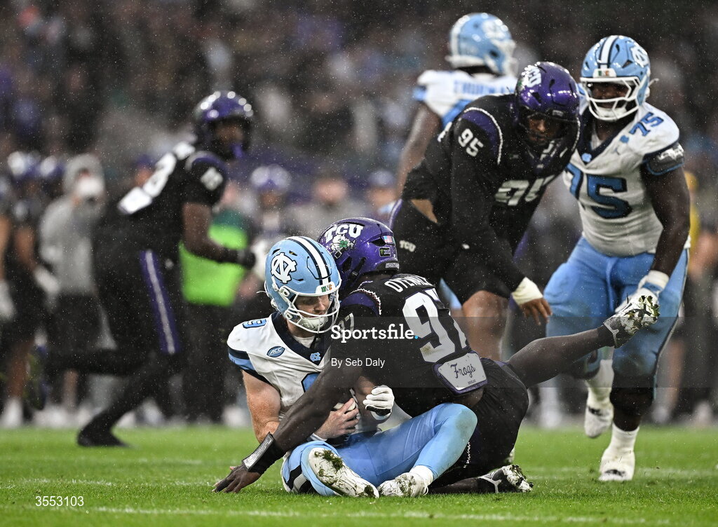 29 August 2026; North Carolina quarterback Billy Edwards Jr #9 is tackled late by TCU edge Paul Oyewale #97 during the 2026 Aer Lingus College Football Classic match between TCU and North Carolina at the Aviva Stadium in Dublin. Photo by Seb Daly/Sportsfile