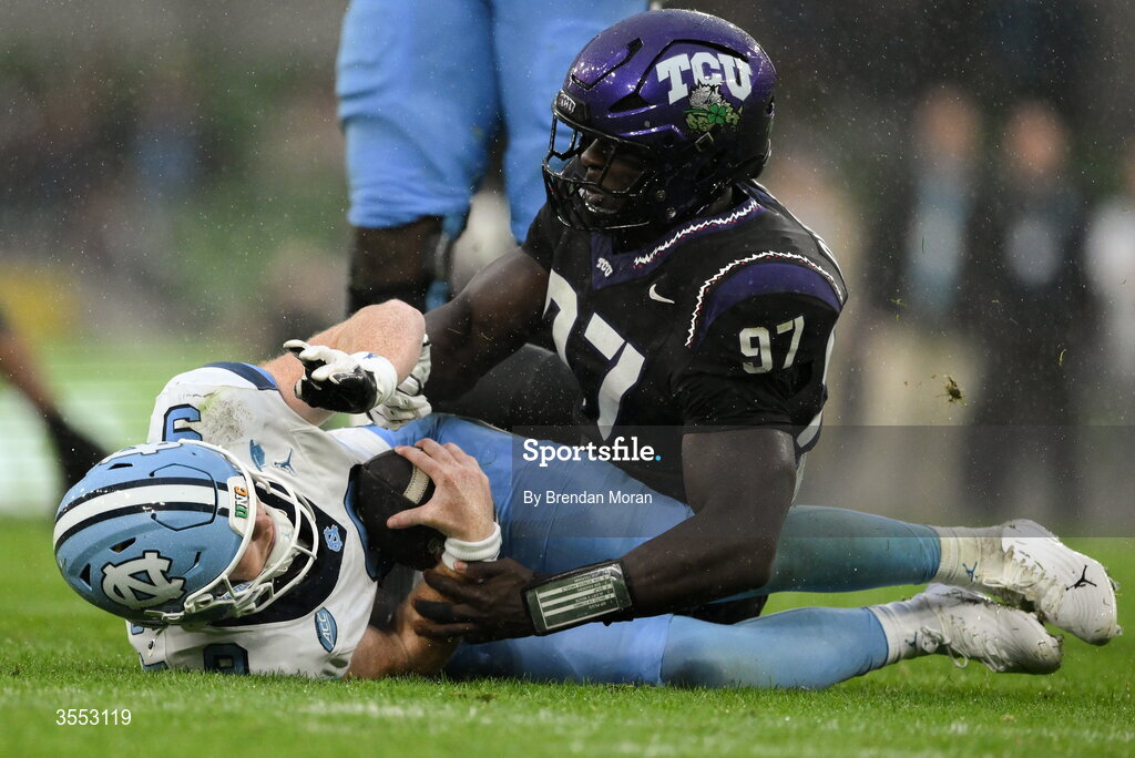 29 August 2026; North Carolina quarterback Billy Edwards Jr #9 is tackled by TCU edge Paul Oyewale #97 during the 2026 Aer Lingus College Football Classic match between TCU and North Carolina at the Aviva Stadium in Dublin. Photo by Brendan Moran/Sportsfile