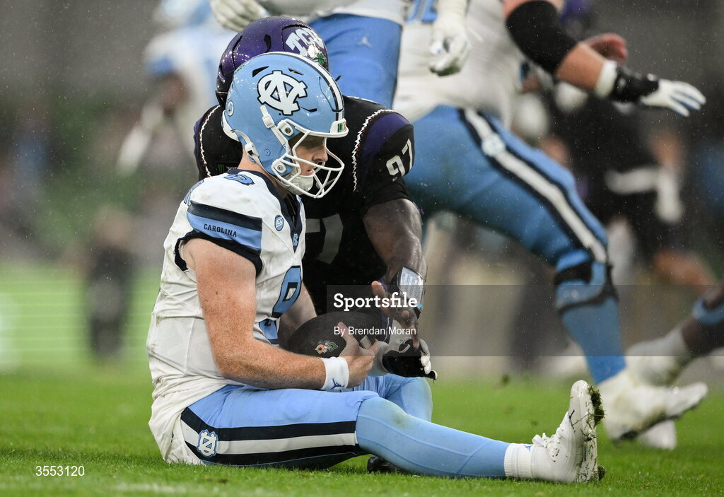 29 August 2026; North Carolina quarterback Billy Edwards Jr #9 is tackled by TCU edge Paul Oyewale #97 during the 2026 Aer Lingus College Football Classic match between TCU and North Carolina at the Aviva Stadium in Dublin. Photo by Brendan Moran/Sportsfile
