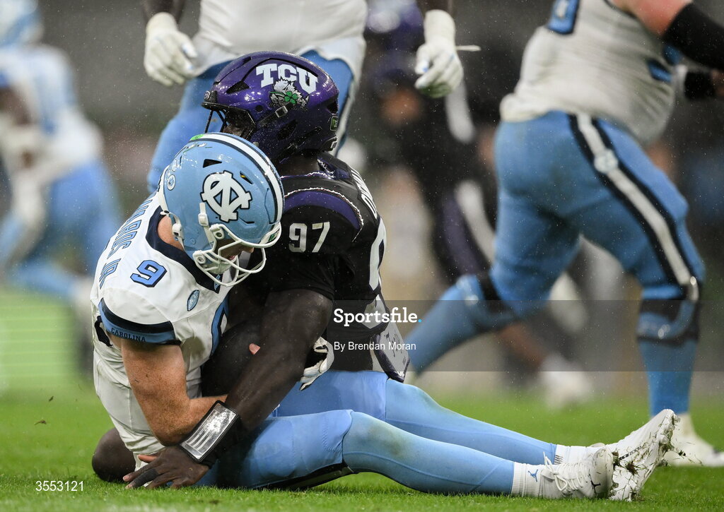 29 August 2026; North Carolina quarterback Billy Edwards Jr #9 is tackled by TCU edge Paul Oyewale #97 during the 2026 Aer Lingus College Football Classic match between TCU and North Carolina at the Aviva Stadium in Dublin. Photo by Brendan Moran/Sportsfile