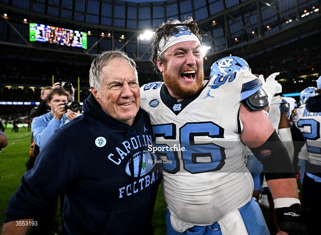 29 August 2026; North Carolina Head Coach Bill Belichick with North Carolina offensive lineman Christo Kelly #56 after their side's victory in the 2026 Aer Lingus College Football Classic match between TCU and North Carolina at the Aviva Stadium in Dublin. Photo by Seb Daly/Sportsfile