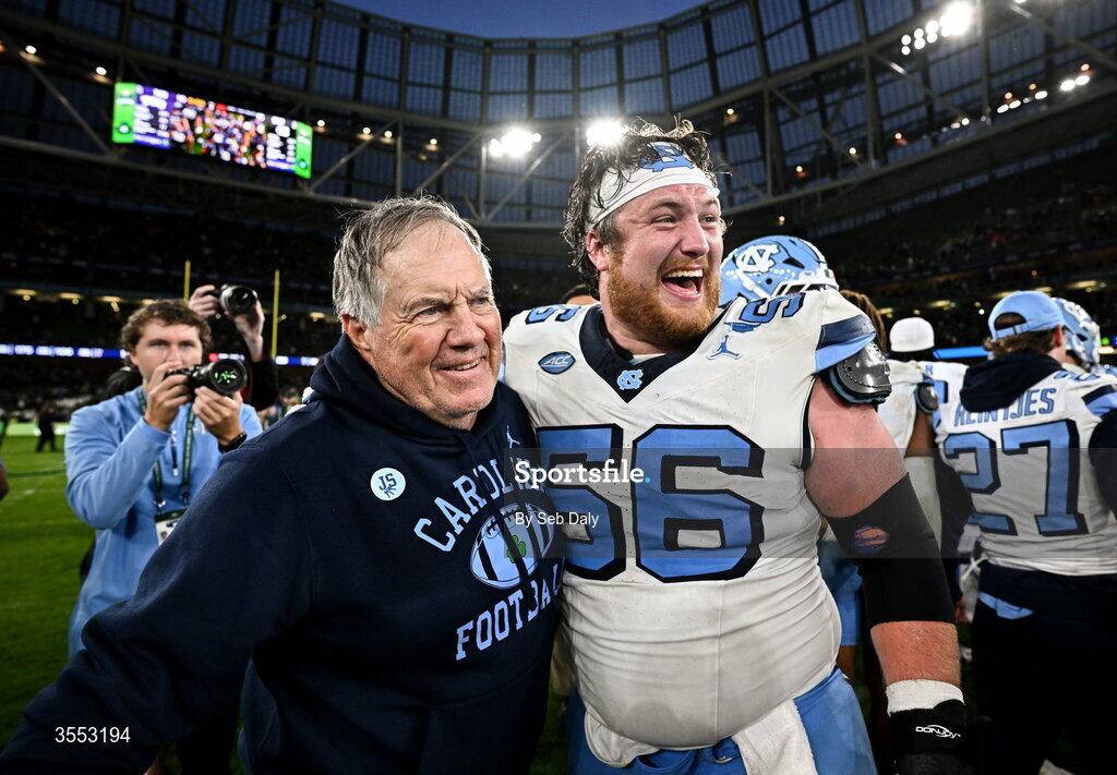 29 August 2026; North Carolina Head Coach Bill Belichick with North Carolina offensive lineman Christo Kelly #56 after their side's victory in the 2026 Aer Lingus College Football Classic match between TCU and North Carolina at the Aviva Stadium in Dublin. Photo by Seb Daly/Sportsfile