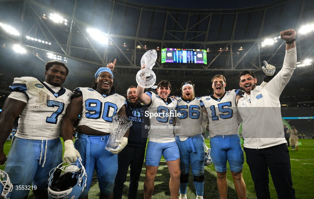 29 August 2026; North Carolina punter Adam McCann-Gibbs #91 and teammates celebrate with the trophy after his side's victory in the 2026 Aer Lingus College Football Classic match between TCU and North Carolina at the Aviva Stadium in Dublin. Photo by Brendan Moran/Sportsfile