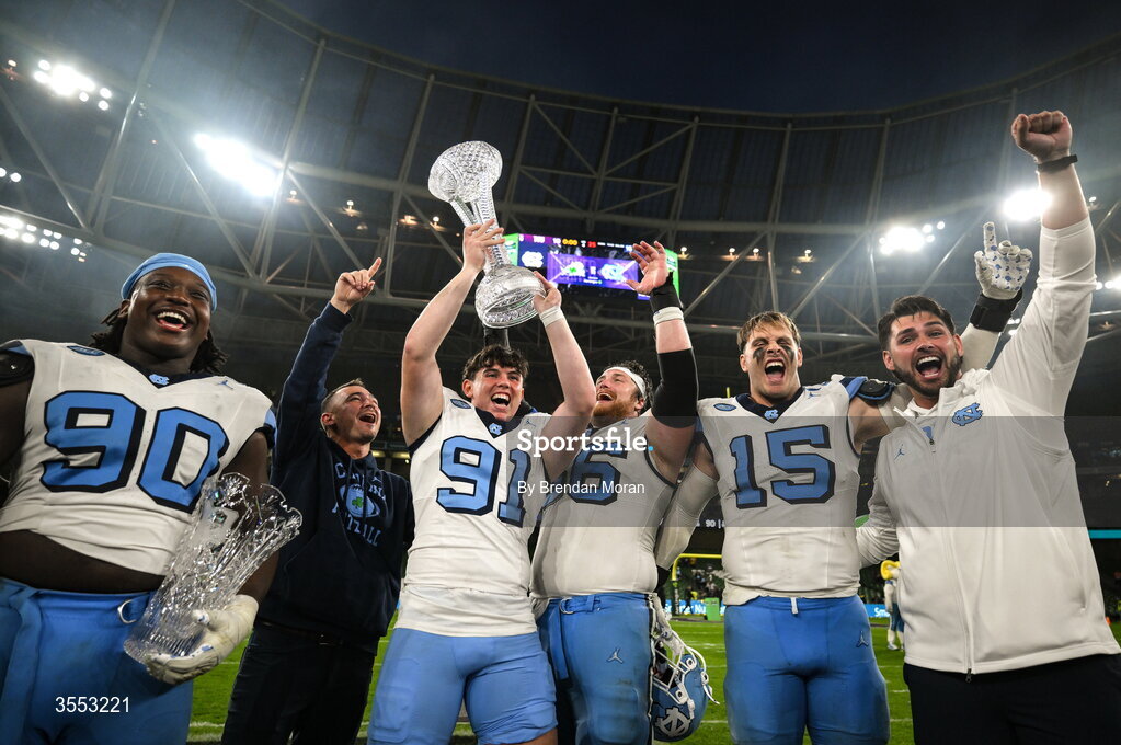 29 August 2026; North Carolina punter Adam McCann-Gibbs #91 and teammates celebrate with the trophy after his side's victory in the 2026 Aer Lingus College Football Classic match between TCU and North Carolina at the Aviva Stadium in Dublin. Photo by Brendan Moran/Sportsfile