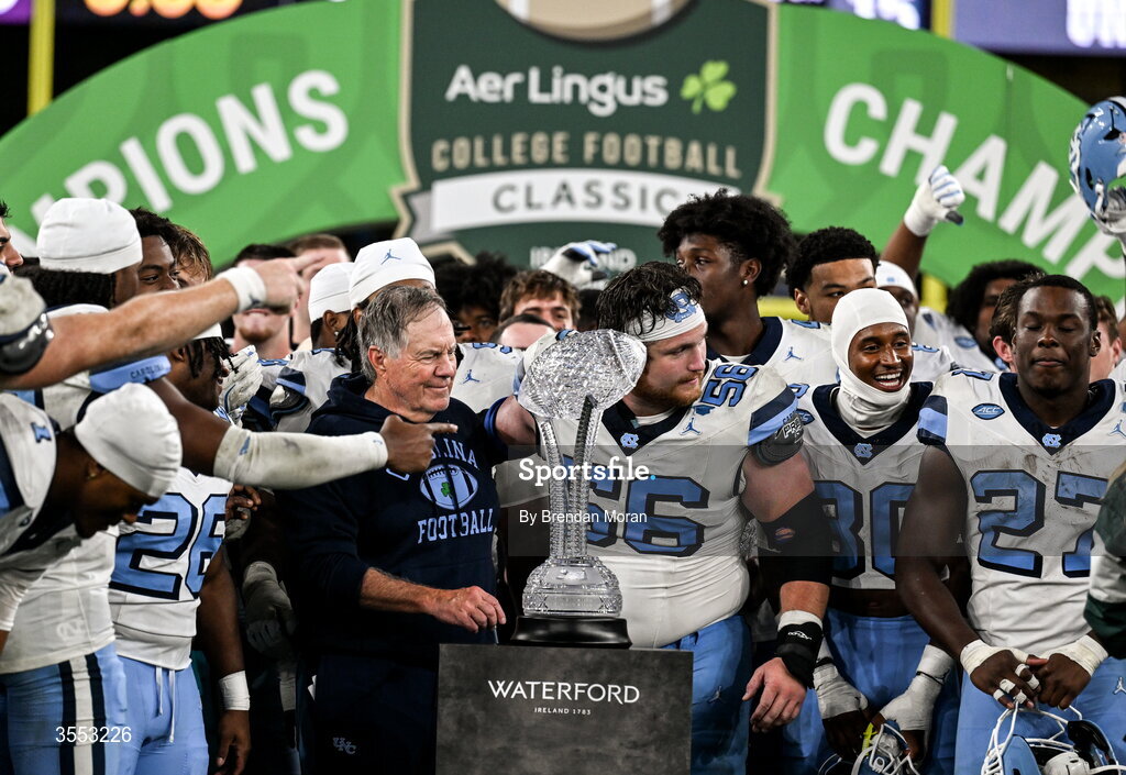 29 August 2026; North Carolina Head Coach Bill Belichick and North Carolina offensive lineman Christo Kelly #56 with the trophy after the 2026 Aer Lingus College Football Classic match between TCU and North Carolina at the Aviva Stadium in Dublin. Photo by Brendan Moran/Sportsfile